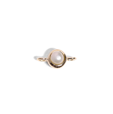 Gold ring with a pearl on a white background