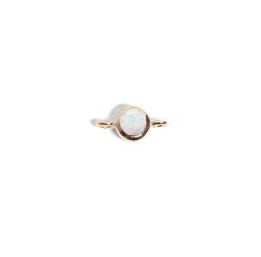 Gold ring with a central opal stone on a white background