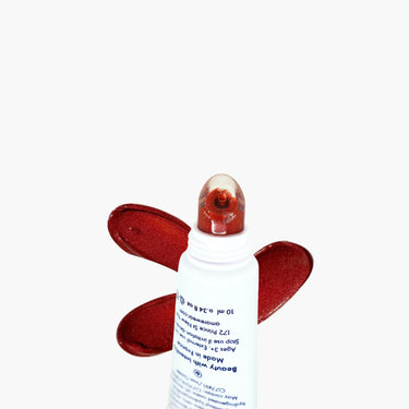 White bottle with red butterfly wings on a white background